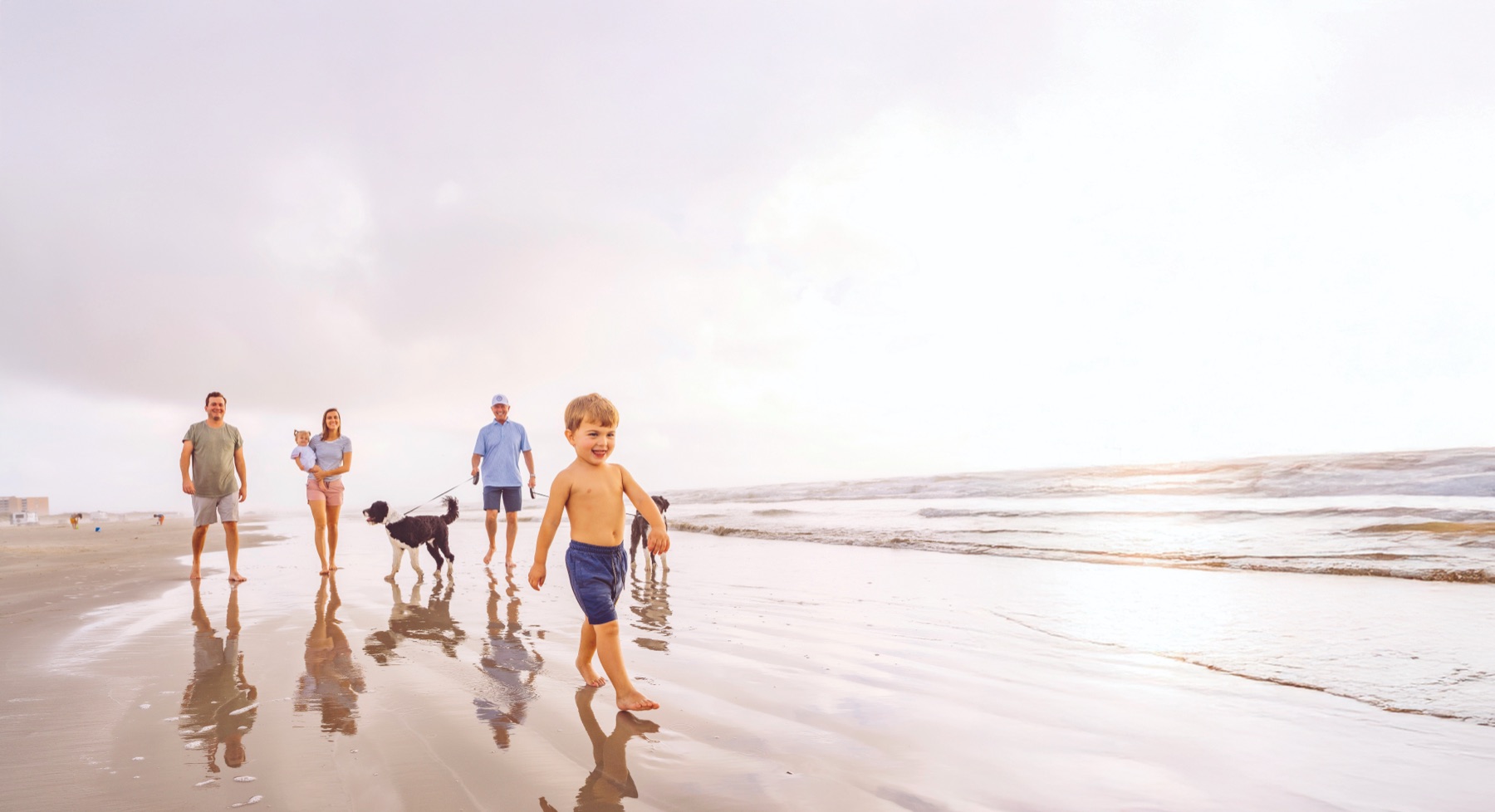 A family enjoying a walk along the beach at Palmilla