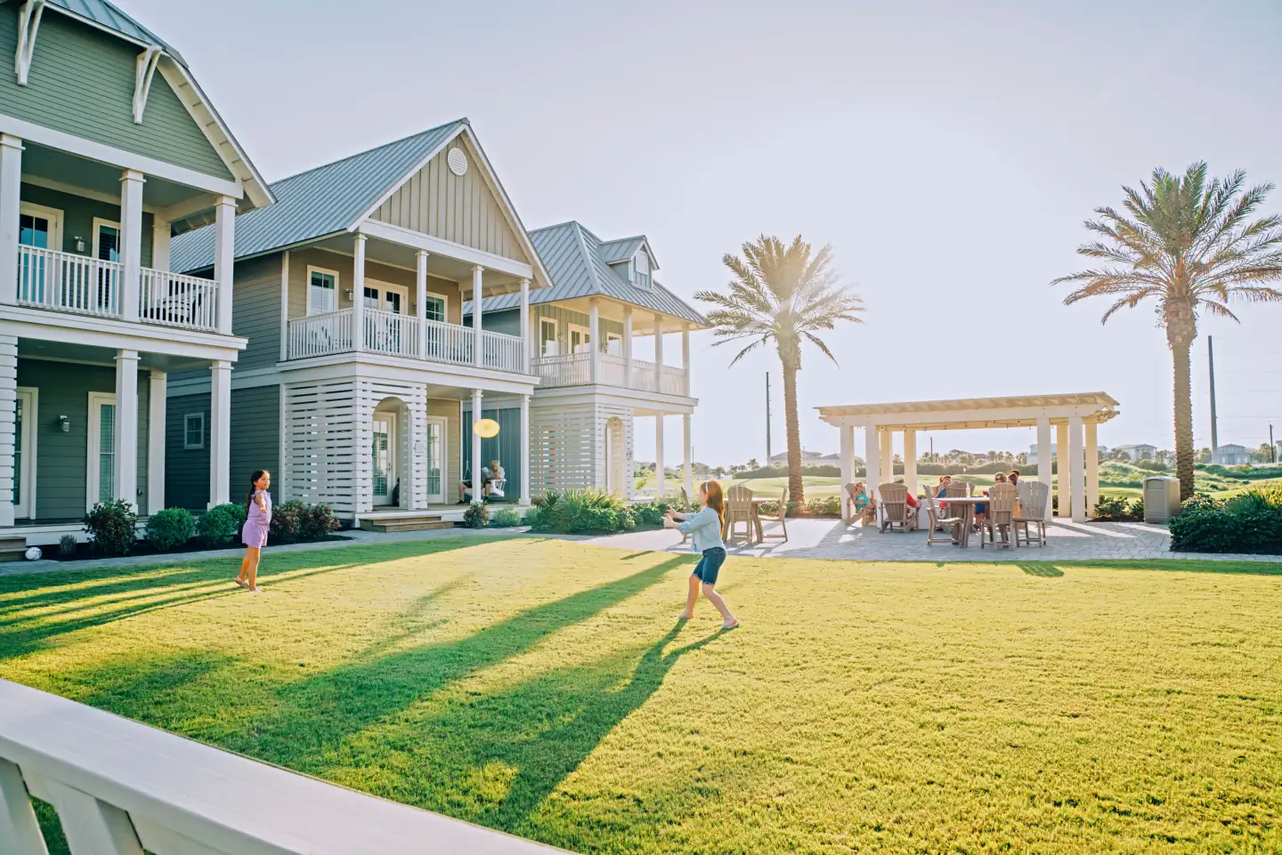 Families enjoying coastal homes and green space at Palmilla Beach