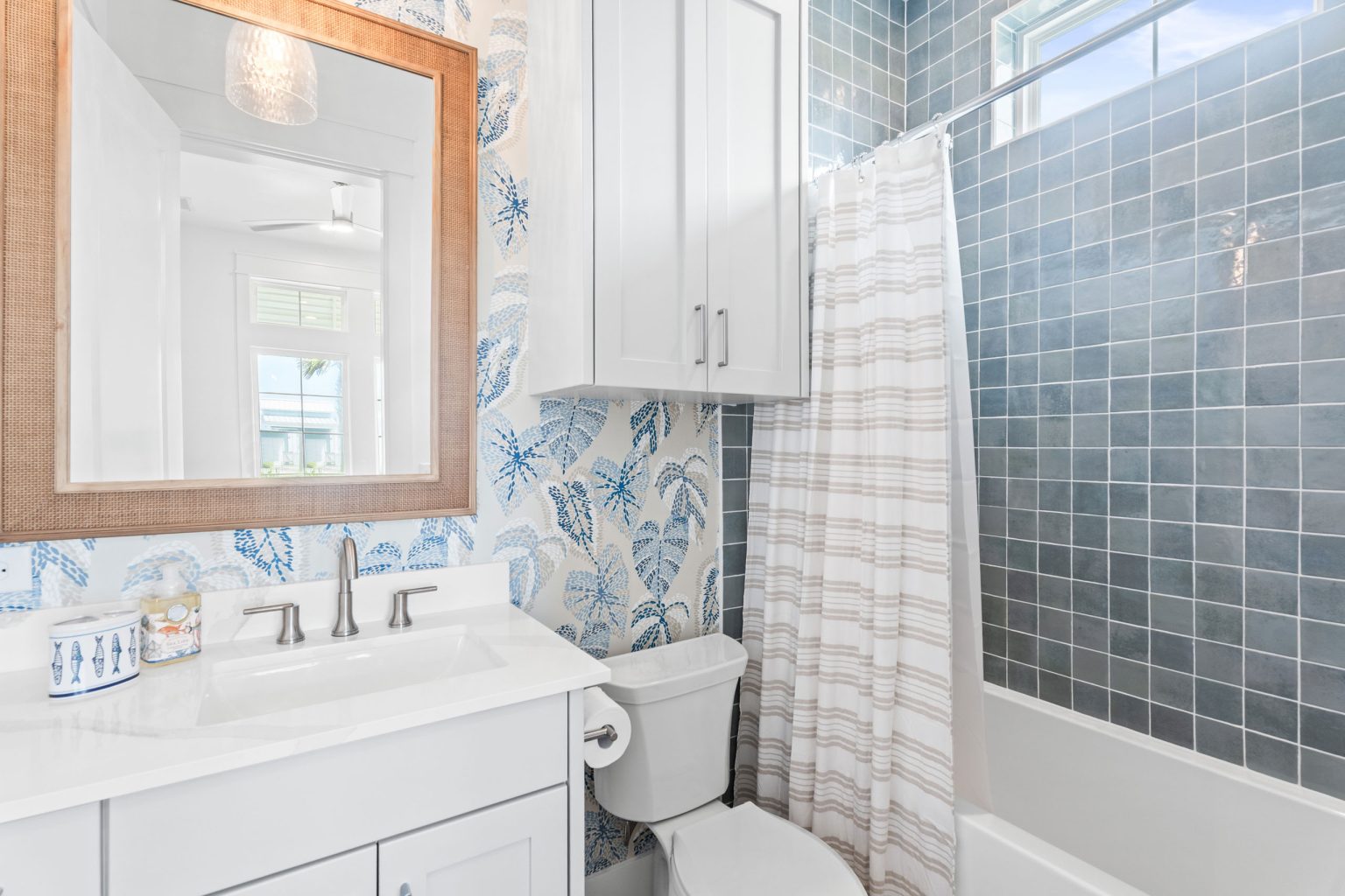 Bathroom with leaf wallpaper and blue tile tub-shower at 205 Horse Tail Lane