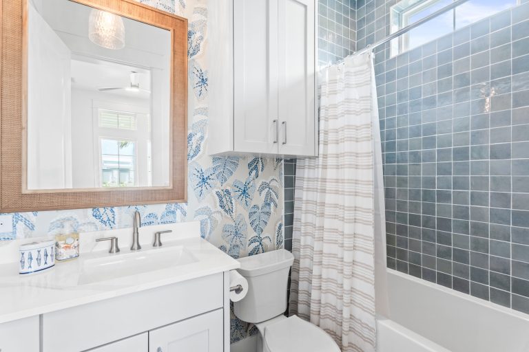 Bathroom with leaf wallpaper and blue tile tub-shower at 205 Horse Tail Lane
