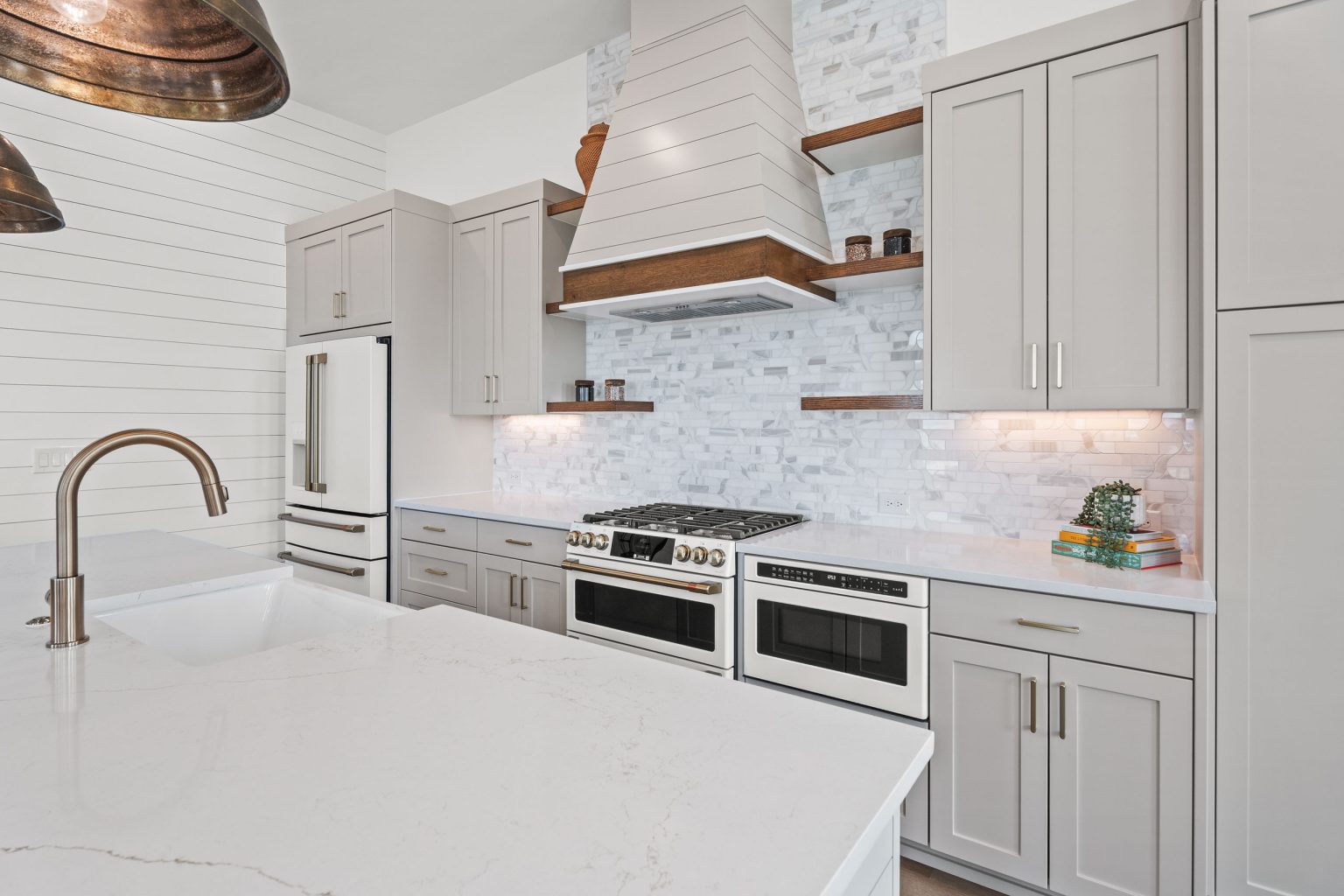 Kitchen with a white range hood and double ovens at 120 Lotus Lane