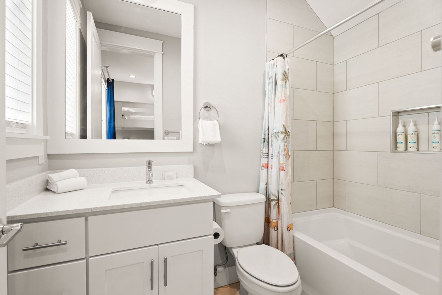 Bathroom with a tub-shower combo and white vanity at 200 Sunset Avenue