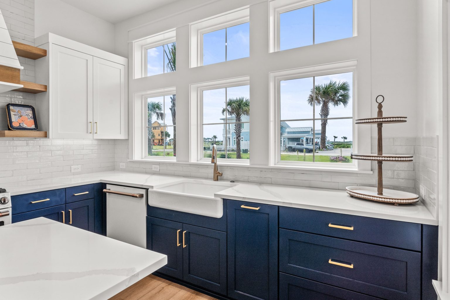 Kitchen sink with farmhouse basin under a wall of windows at 209 Horse Tail Lane