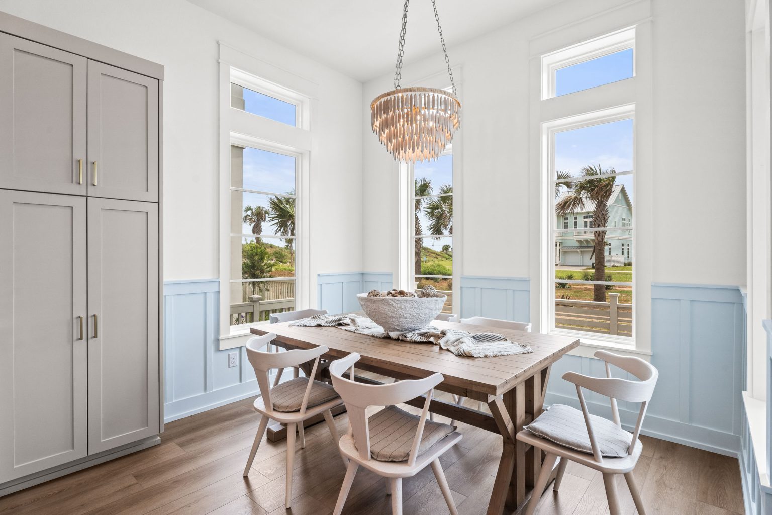 Dining nook with a wood table and beaded chandelier at 120 Lotus Lane
