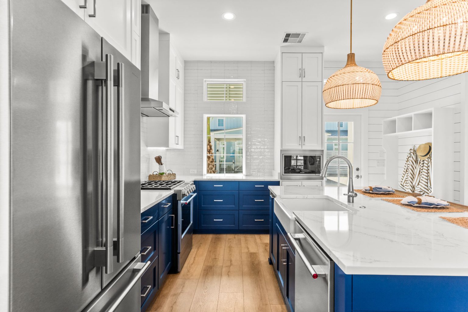 Kitchen with a stainless refrigerator and navy cabinetry at 101 Sea Whip Lane