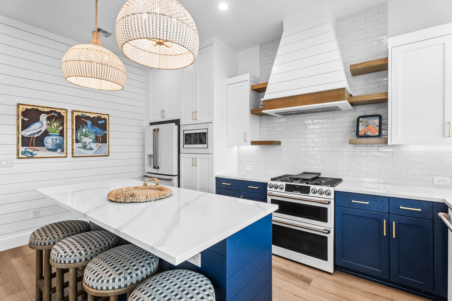 Kitchen island seating, range hood and navy cabinetry at 209 Horse Tail Lane