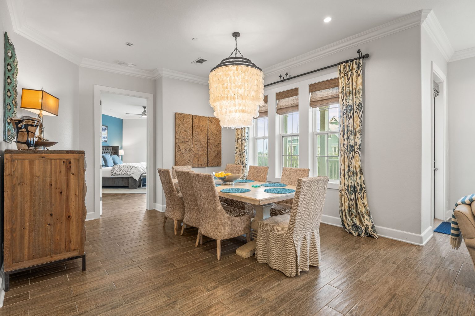 Dining room with a long table and shell chandelier at 137 Palmilla Circle #204