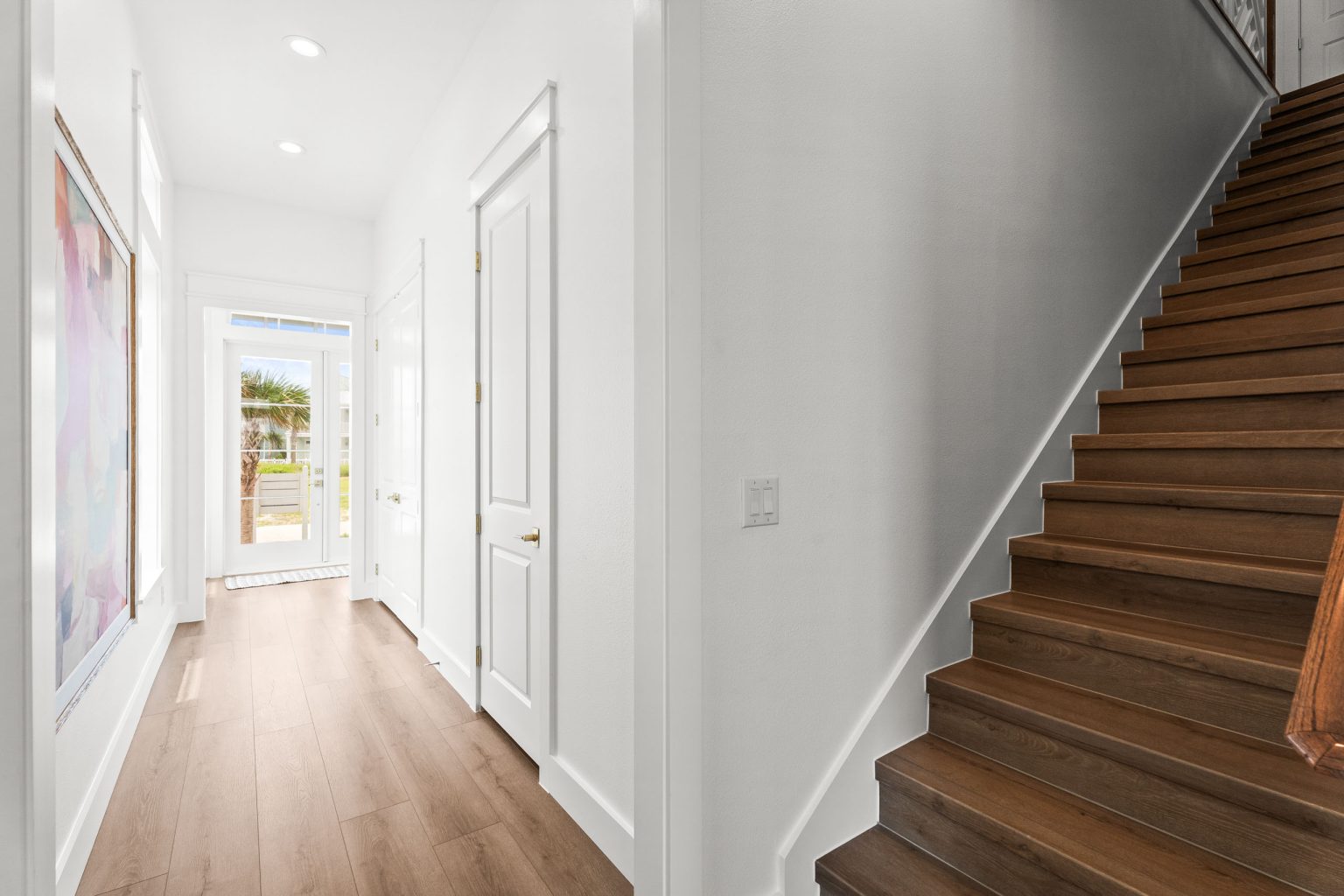 Hallway with a wood staircase at 120 Lotus Lane