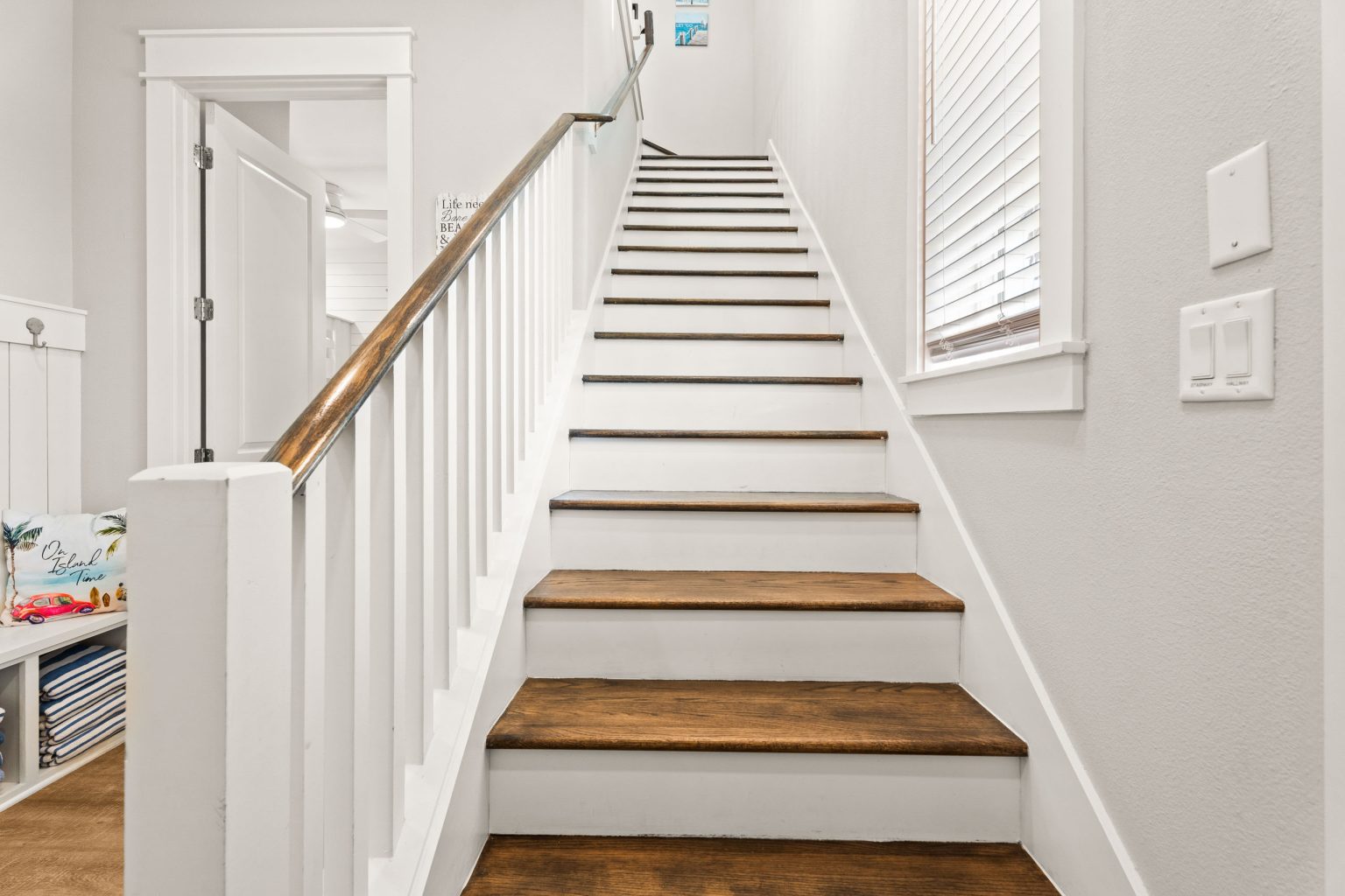 Staircase with white railings and wood treads at 200 Sunset Avenue
