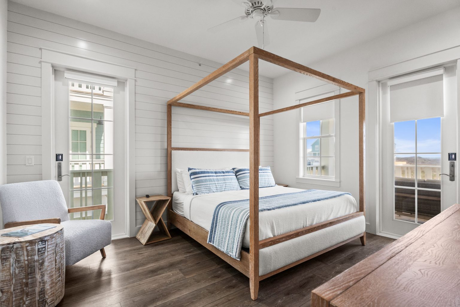 Bedroom with a wood canopy bed and porch doors at 250 Sunrise Avenue