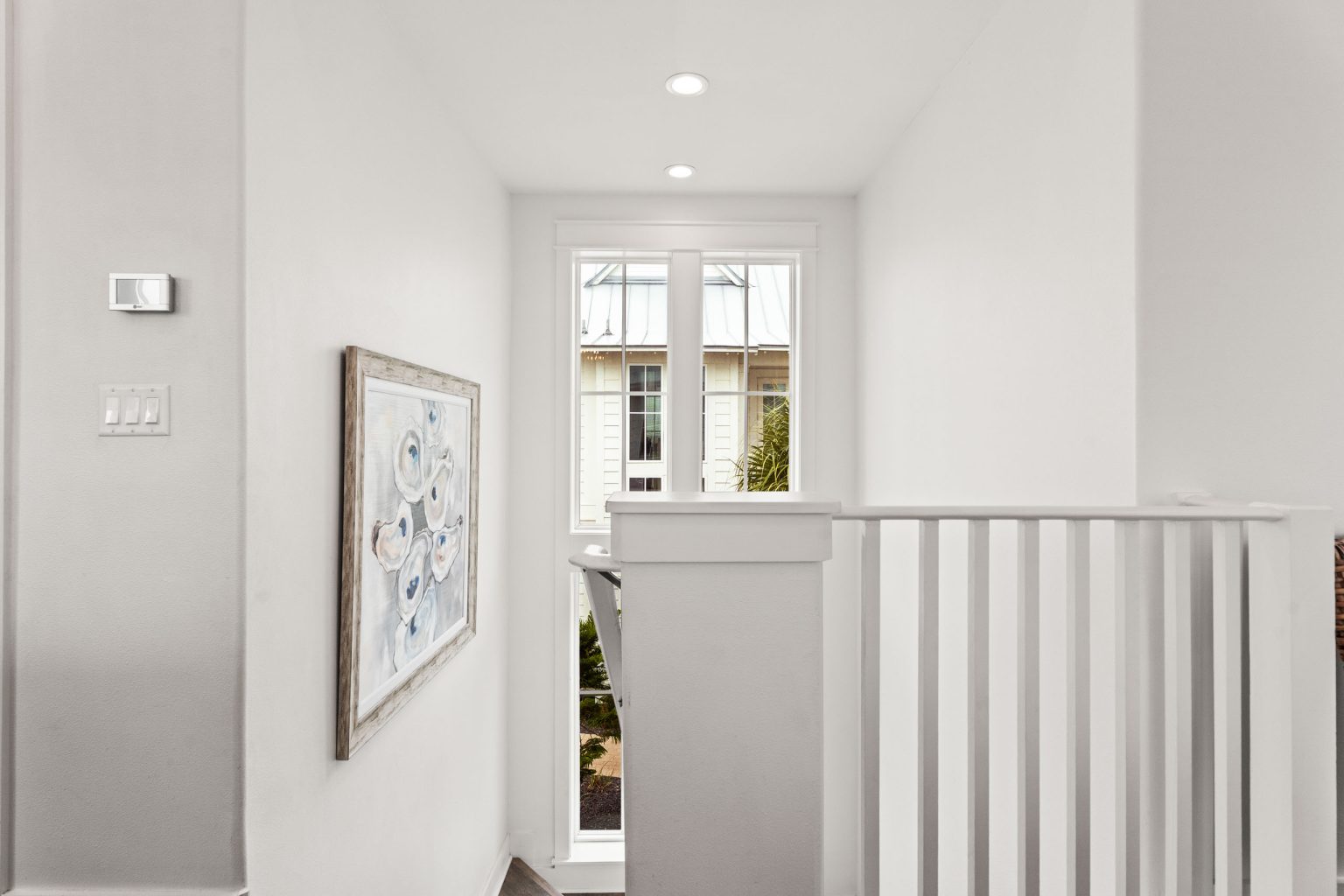 Upstairs landing with white railing at 214 Sunset Avenue #4