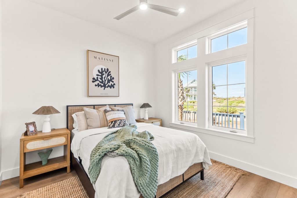 Bedroom with a coral print and garden-view windows at 101 Sea Whip Lane