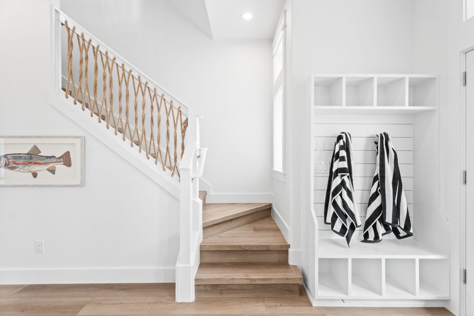 Staircase with rope railing and mudroom cubbies at 205 Horse Tail Lane