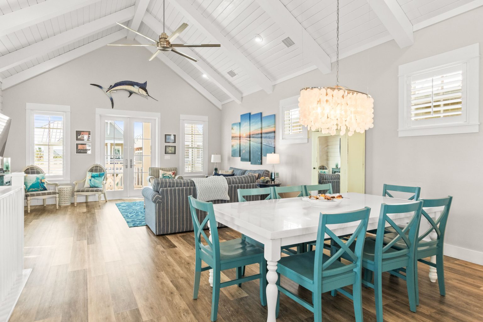 Vaulted great room with a teal dining set and living area at 152 Sea Rocket Lane