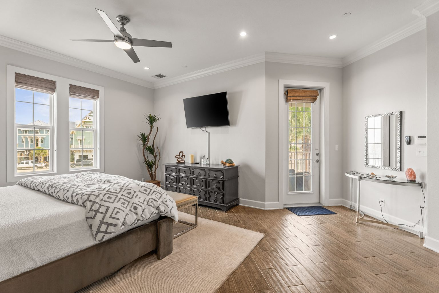 Primary bedroom with a ceiling fan and balcony door at 137 Palmilla Circle #204