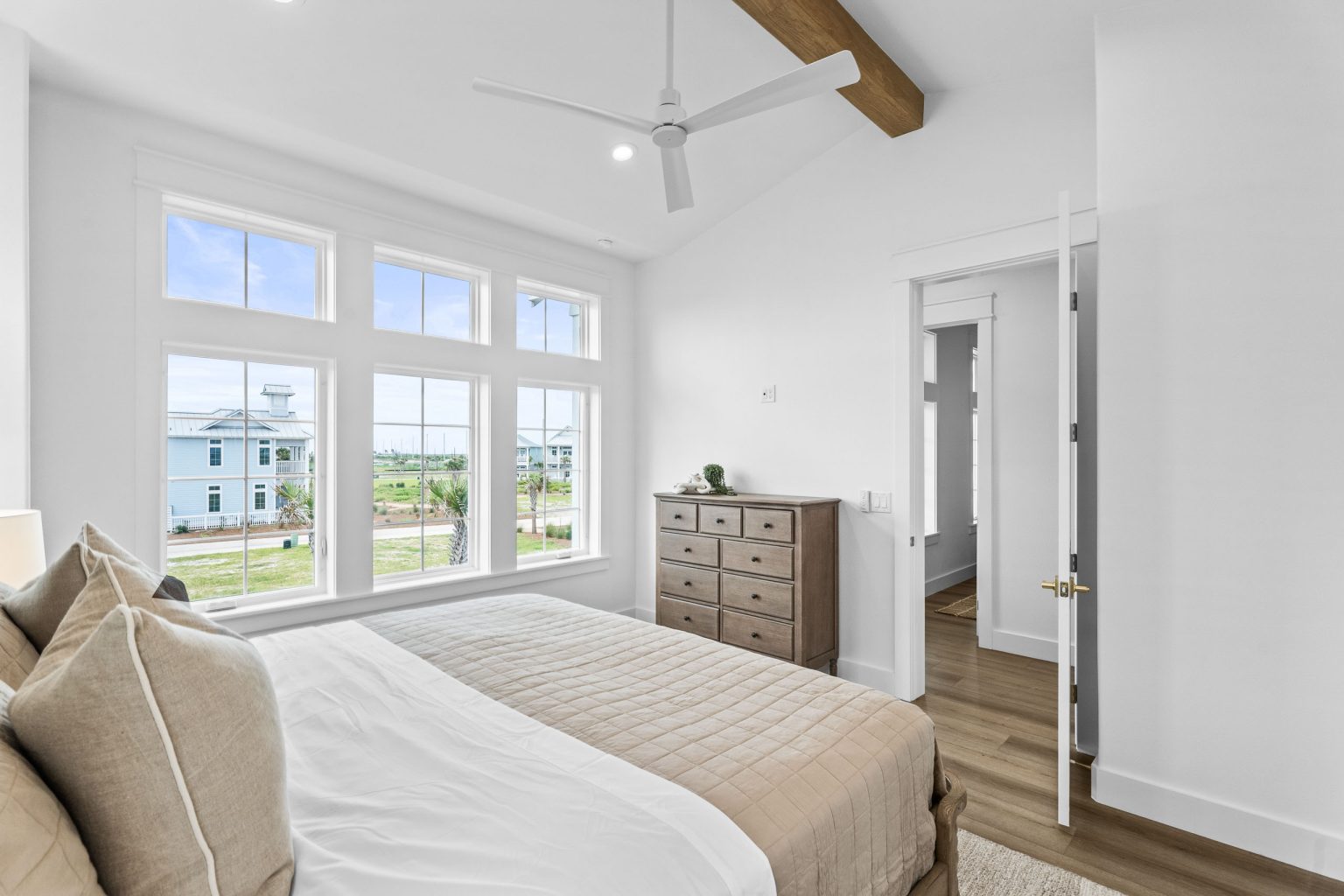 Bedroom with a beamed ceiling and garden views at 209 Horse Tail Lane