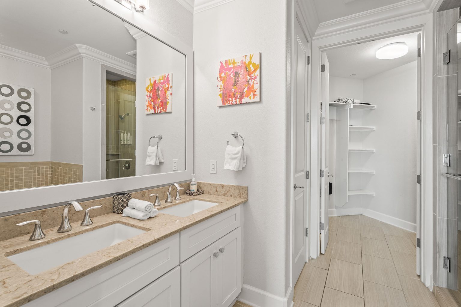 Bathroom with a double vanity and walk-in closet at 137 Palmilla Circle #204
