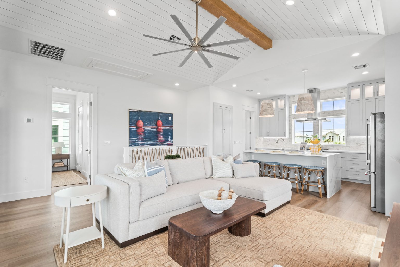 Living room with white sectional, open to the kitchen at 205 Horse Tail Lane