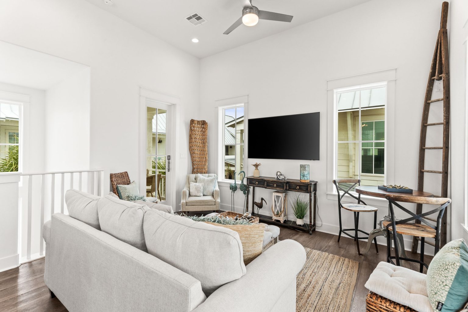 Living room with a white sofa, TV and bistro table at 214 Sunset Avenue #4