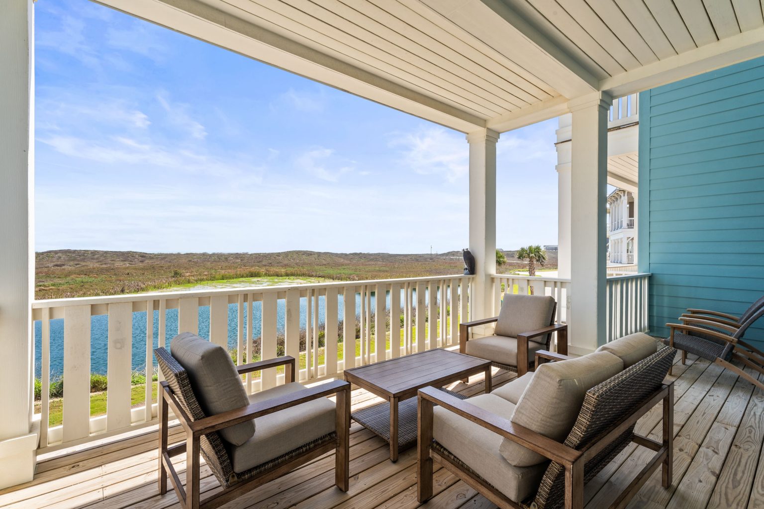 Covered porch with lounge chairs overlooking a pond at 250 Sunrise Avenue