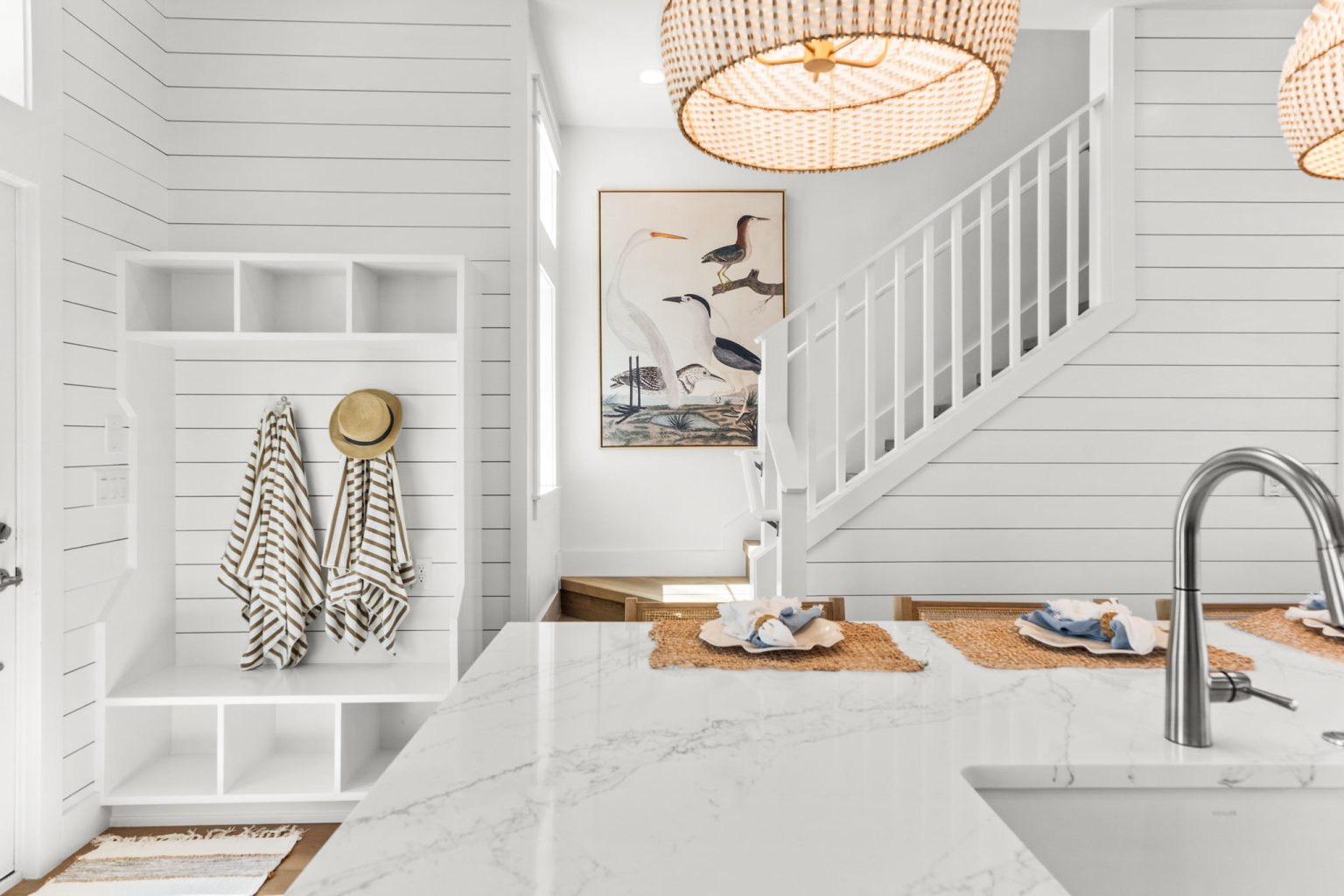 Mudroom cubbies and staircase beside the kitchen at 101 Sea Whip Lane