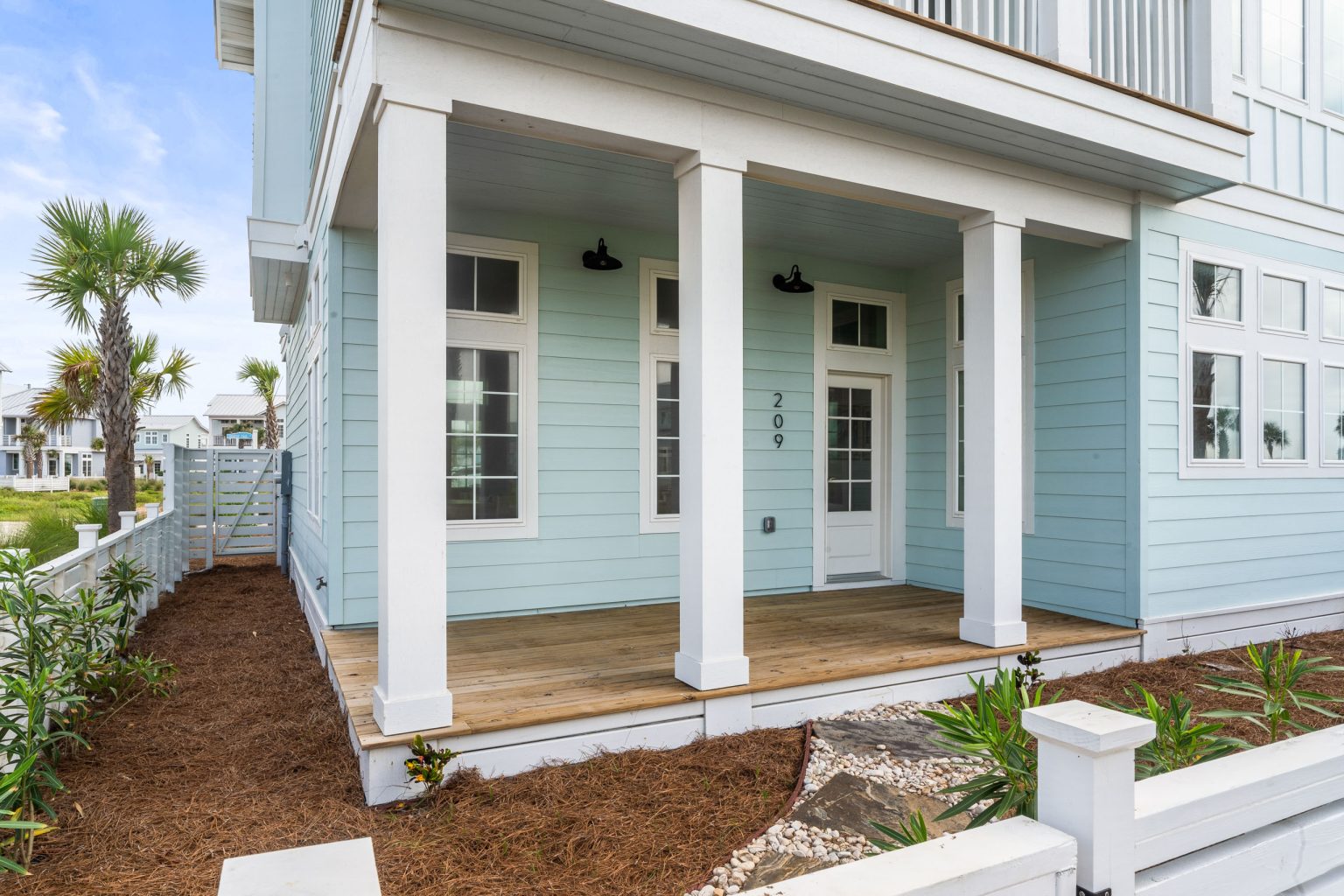 Covered front porch with white columns at 209 Horse Tail Lane