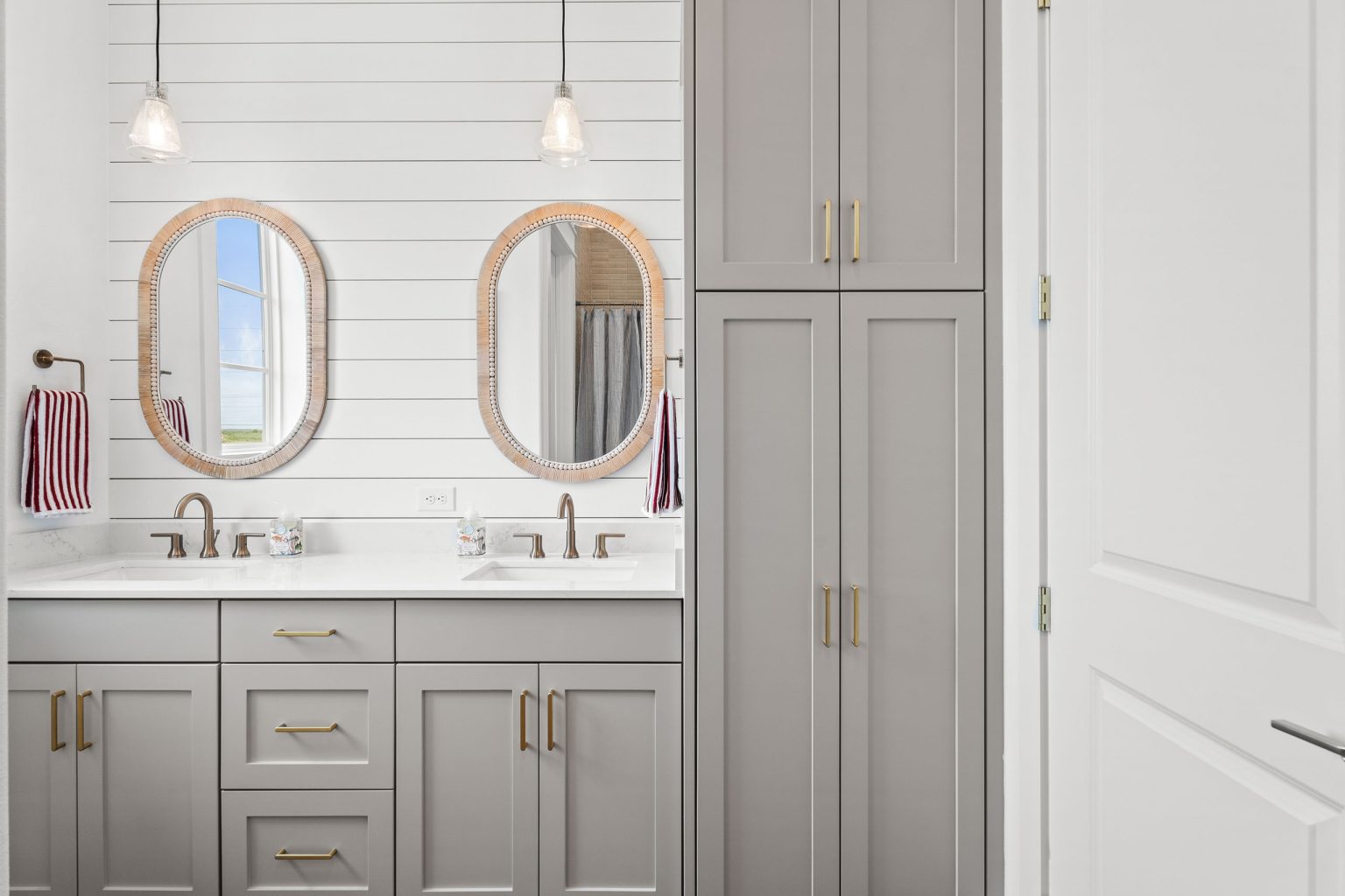 Bathroom with a double vanity and oval mirrors at 120 Lotus Lane