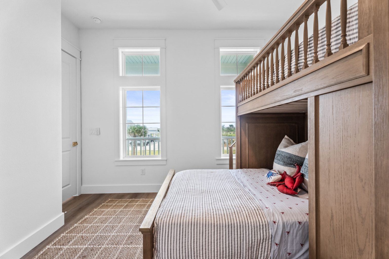 Bunk room with a wooden bunk bed and striped bedding at 209 Horse Tail Lane