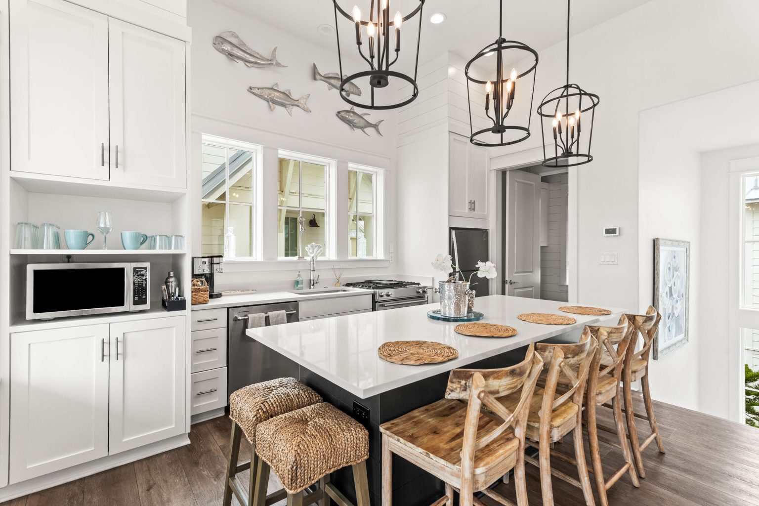 Kitchen with white cabinets and island seating for six at 214 Sunset Avenue #5
