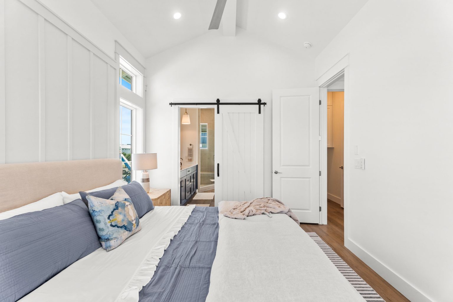 Primary bedroom with a sliding barn door to the bath at 101 Sea Whip Lane