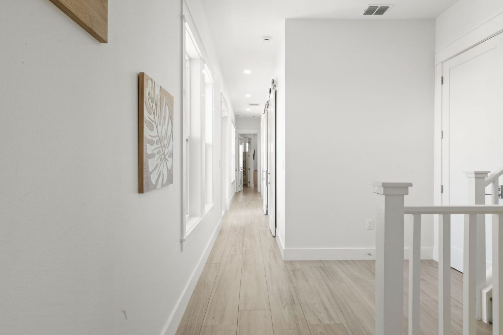 Upstairs hallway with a white railing at 724 Sunset Avenue
