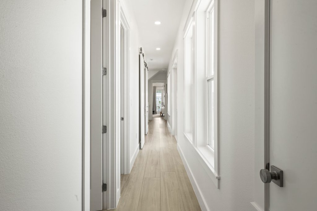 Long hallway with light wood floors at 724 Sunset Avenue