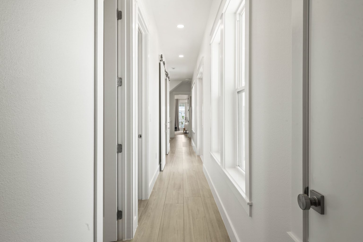 Long hallway with light wood floors at 724 Sunset Avenue