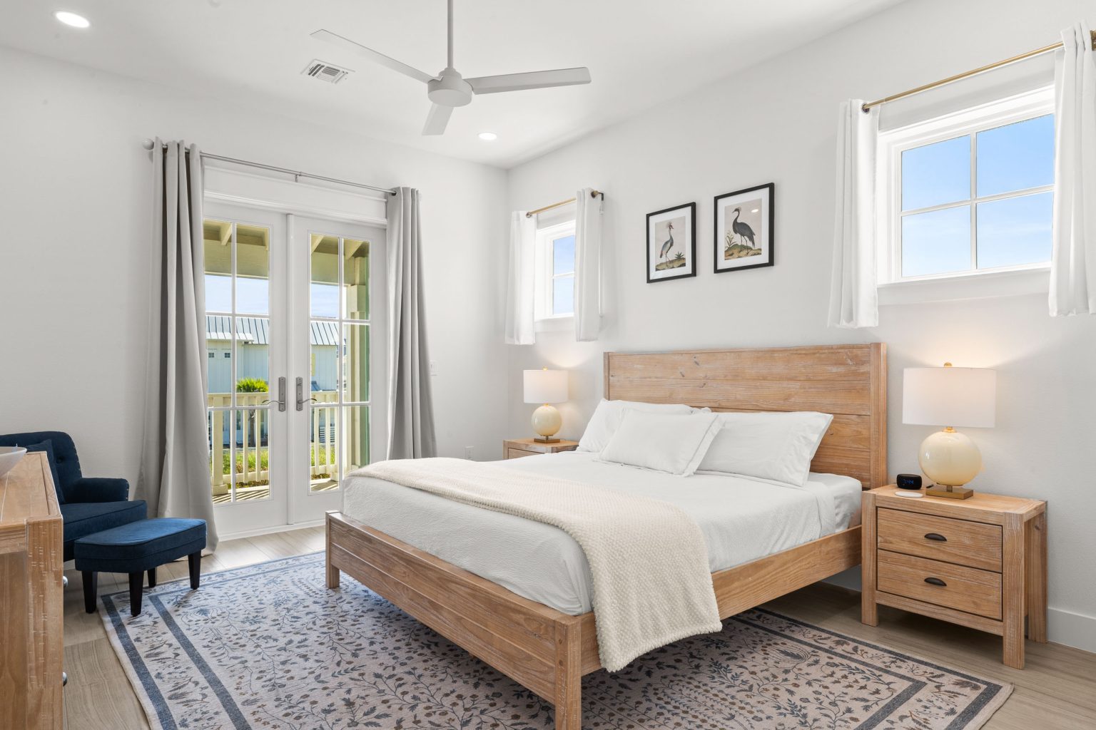 Bedroom with a wood bed and French doors to a balcony at 724 Sunset Avenue