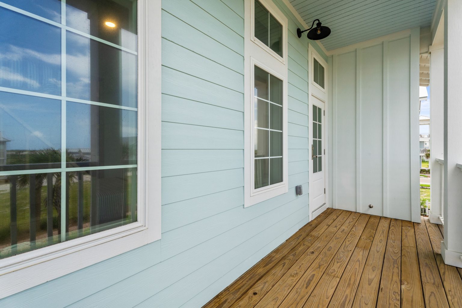 Covered upper porch with pale blue siding at 209 Horse Tail Lane