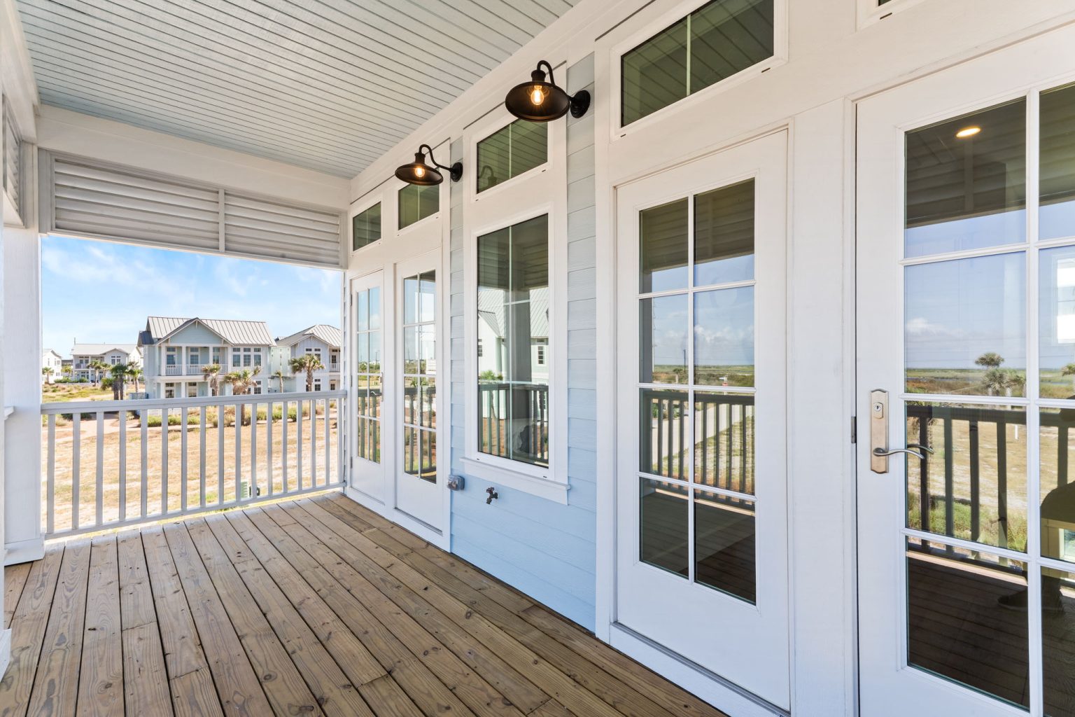 Covered upper porch with French doors at 101 Sea Whip Lane