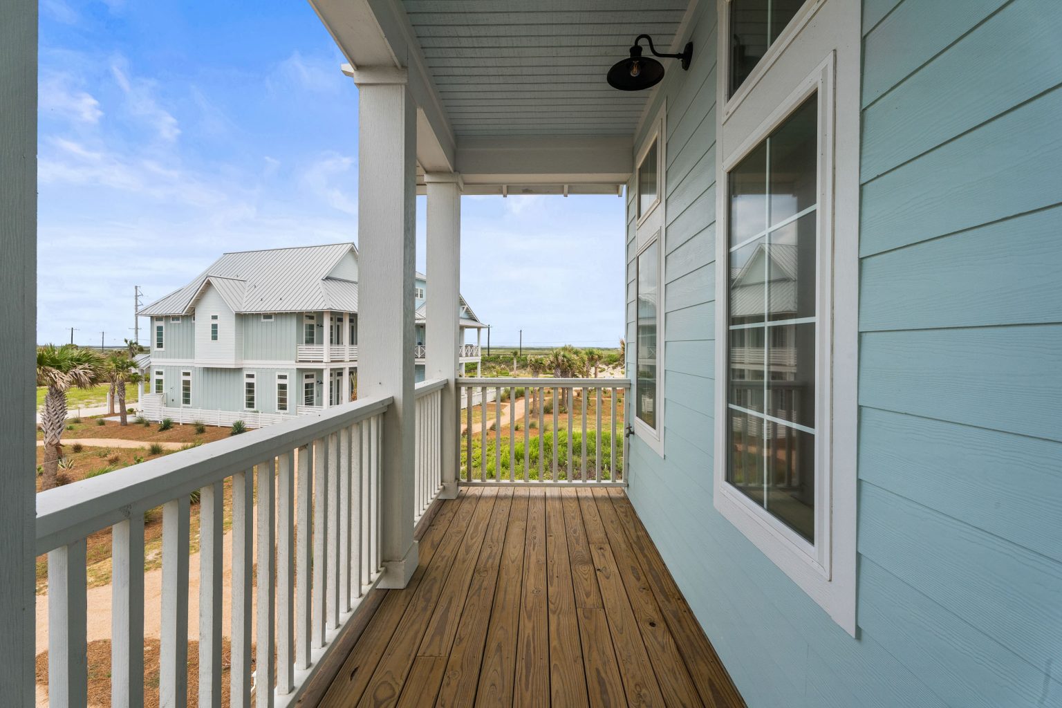 Wraparound porch overlooking neighboring homes at 209 Horse Tail Lane