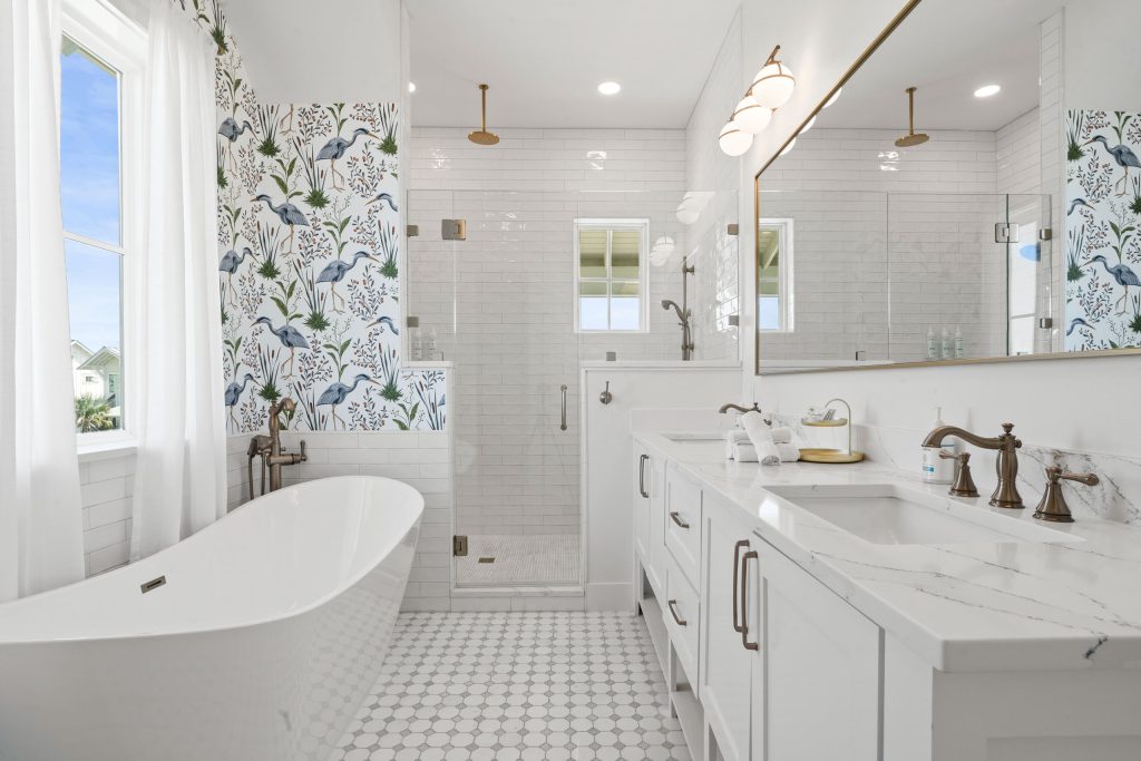 Primary bathroom with a freestanding tub and glass shower at 724 Sunset Avenue