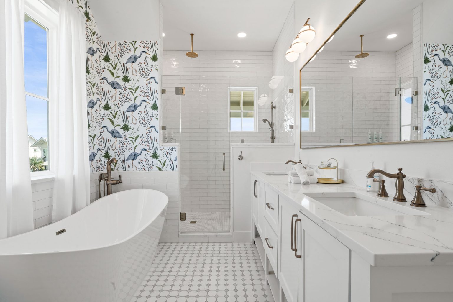 Primary bathroom with a freestanding tub and glass shower at 724 Sunset Avenue
