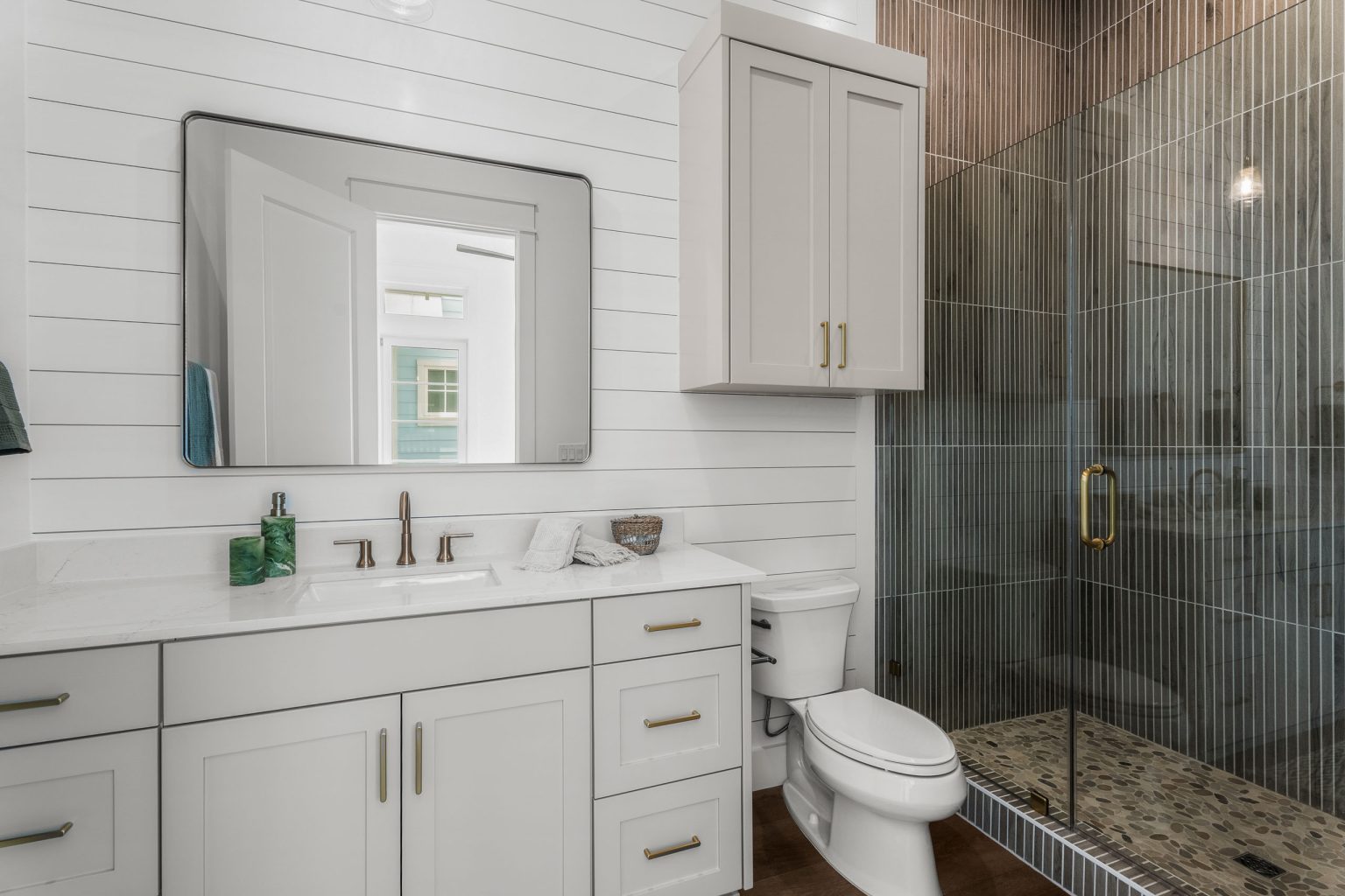 Bathroom with a white vanity and tiled glass shower at 120 Lotus Lane