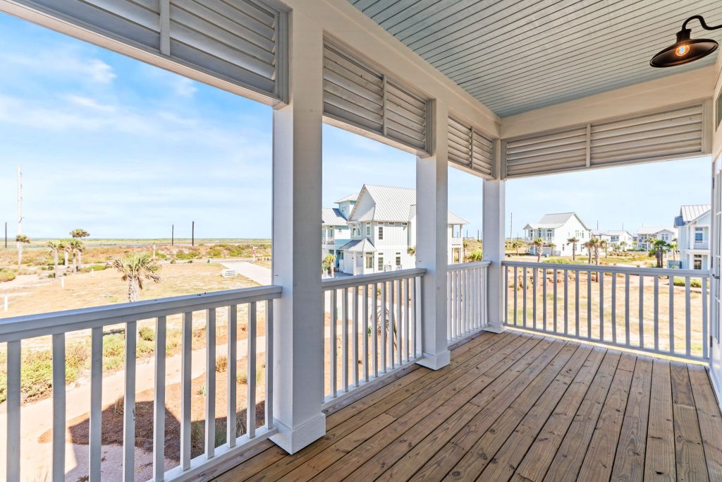 Upper porch overlooking the dunes and neighboring homes at 101 Sea Whip Lane
