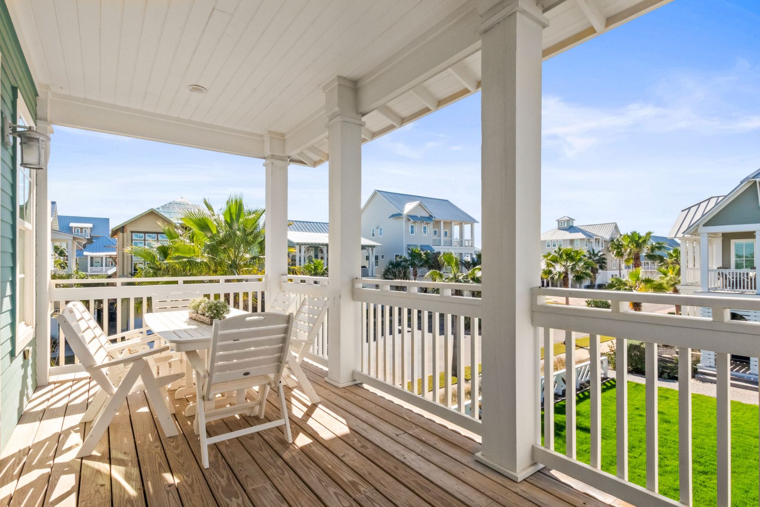 Covered porch with dining table overlooking the lawn at 152 Sea Rocket Lane
