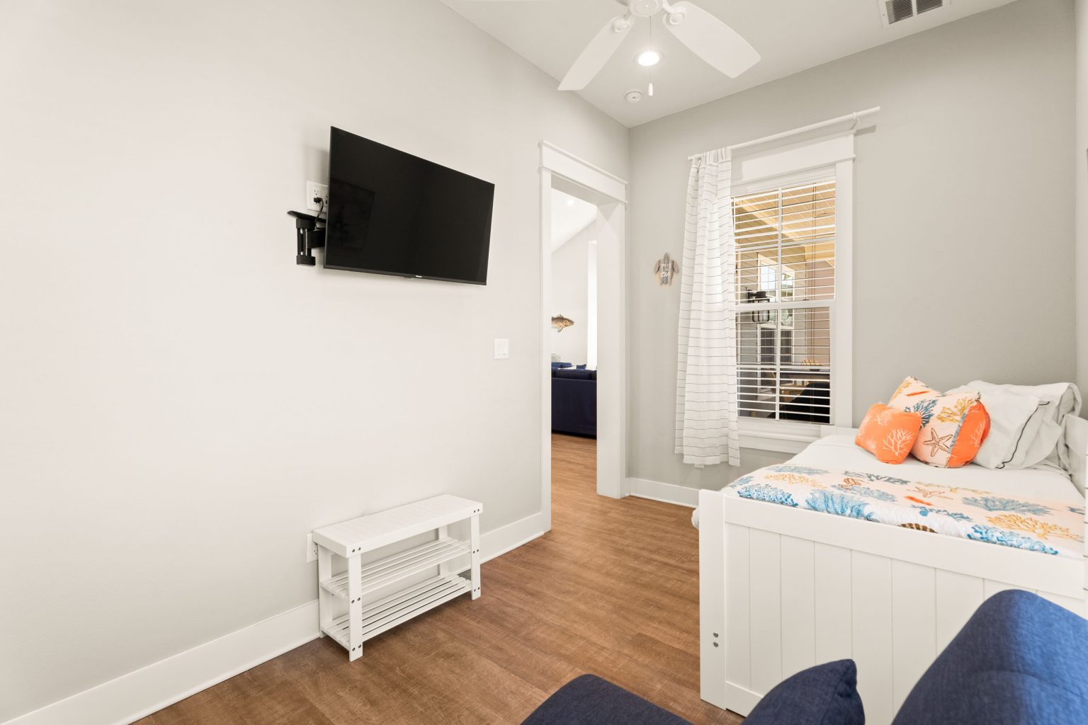 Bedroom with a white daybed and wall-mounted TV at 200 Sunset Avenue