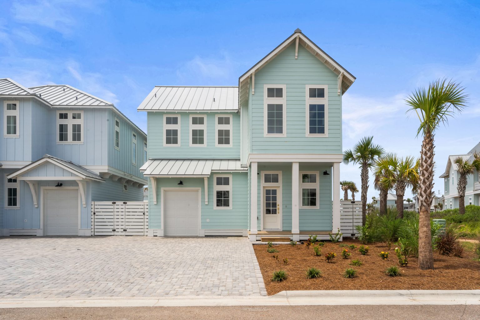 Front of 209 Horse Tail Lane with a paver driveway and attached garage