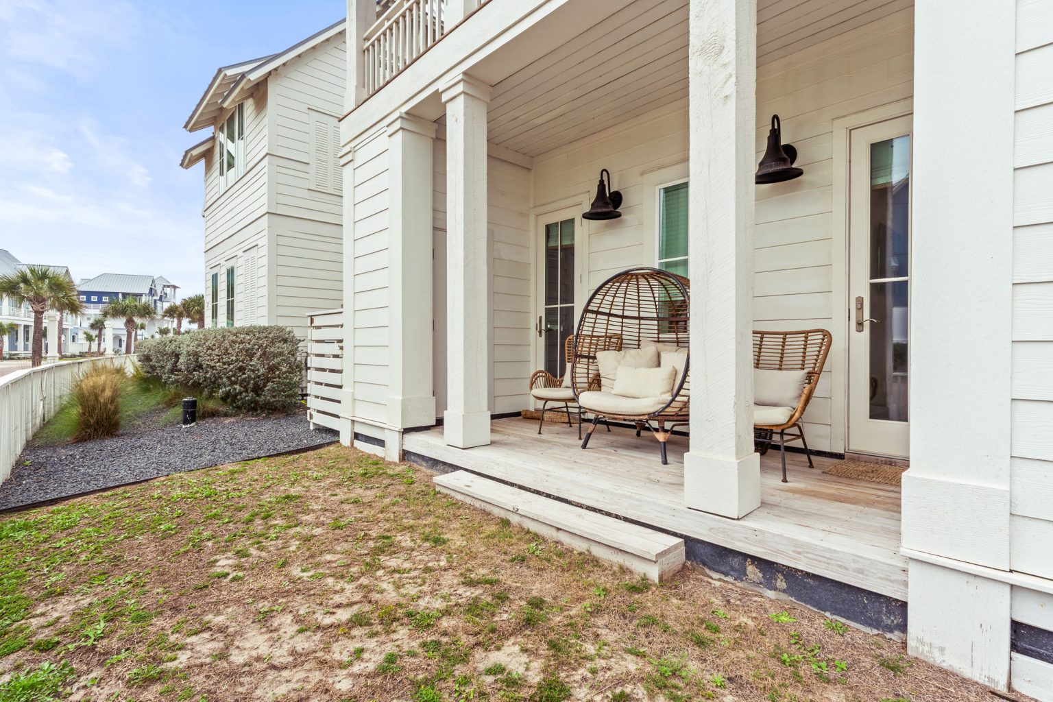 Covered ground-floor porch with egg chair seating at 214 Sunset Avenue #5