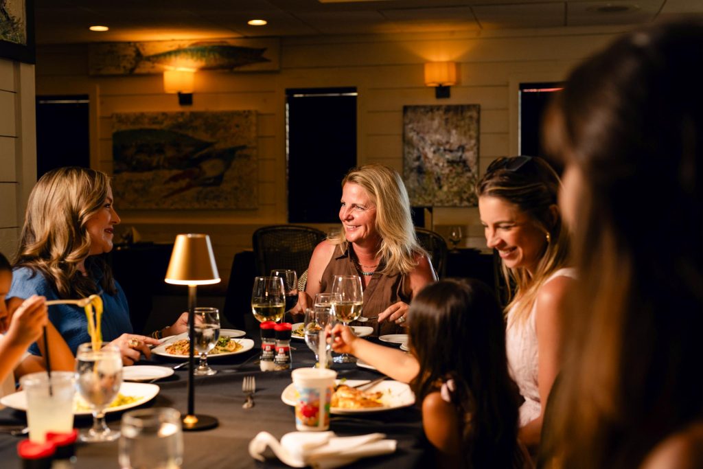Friends sharing dinner at a Palmilla Beach restaurant