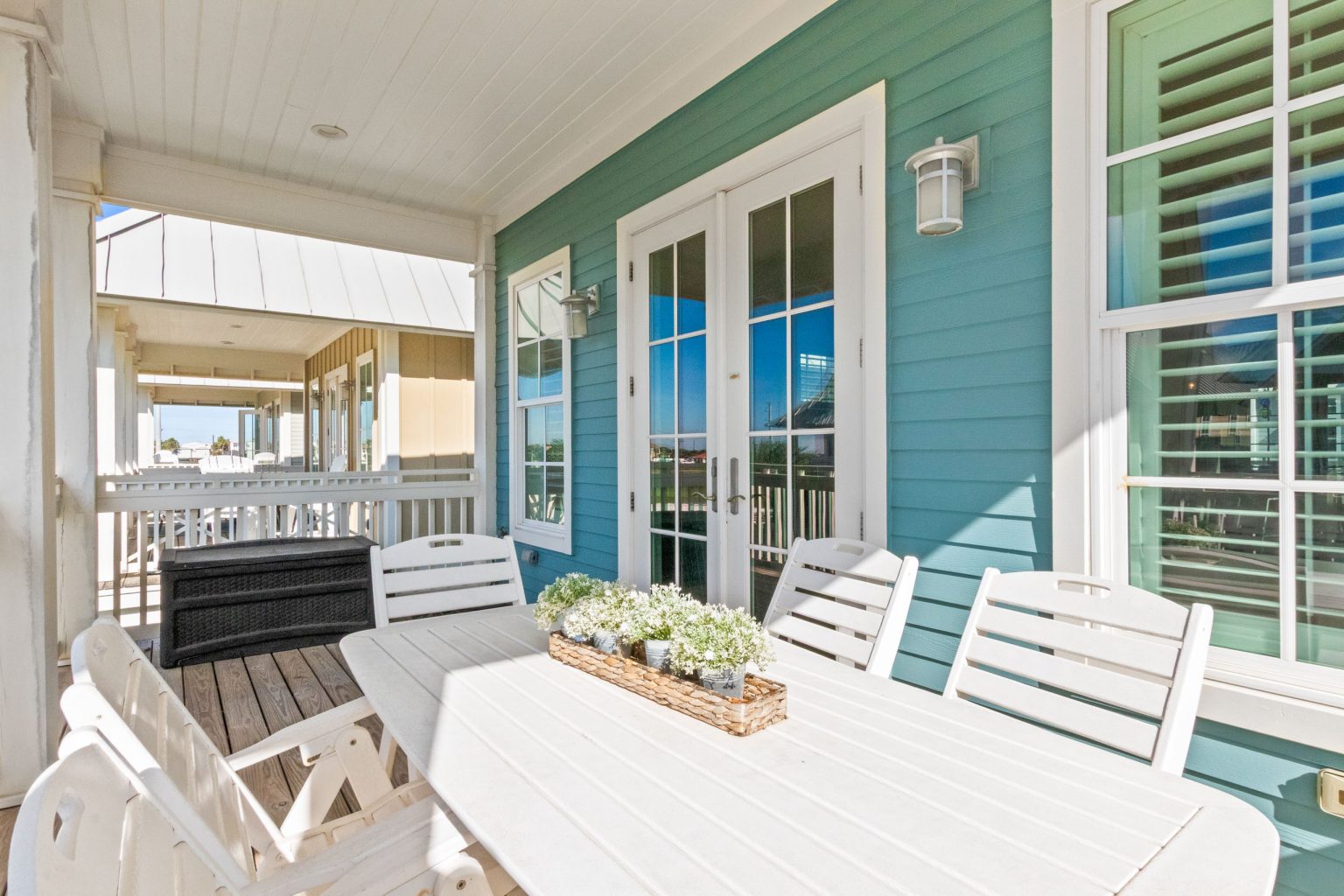 Porch dining table beside French doors at 152 Sea Rocket Lane