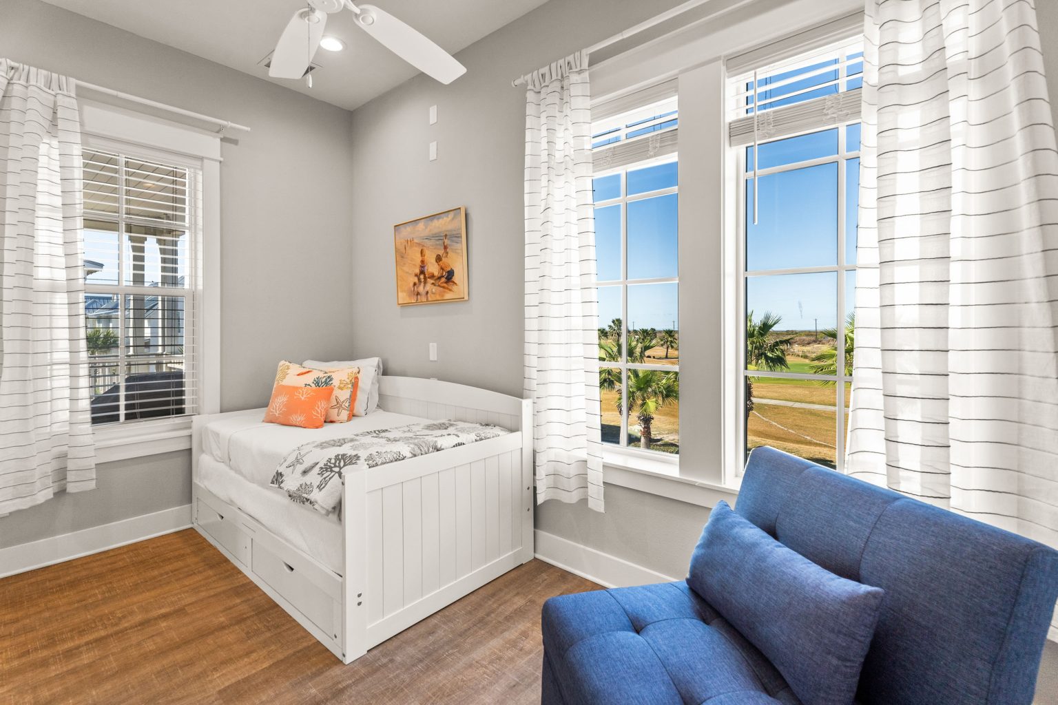 Bedroom with a trundle daybed and bright windows at 200 Sunset Avenue