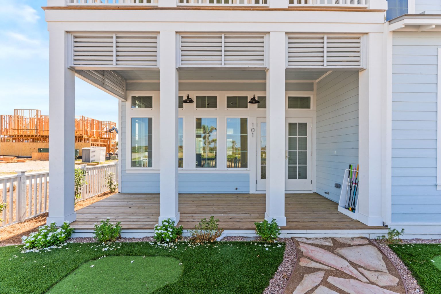 Covered porch with a backyard putting green at 101 Sea Whip Lane