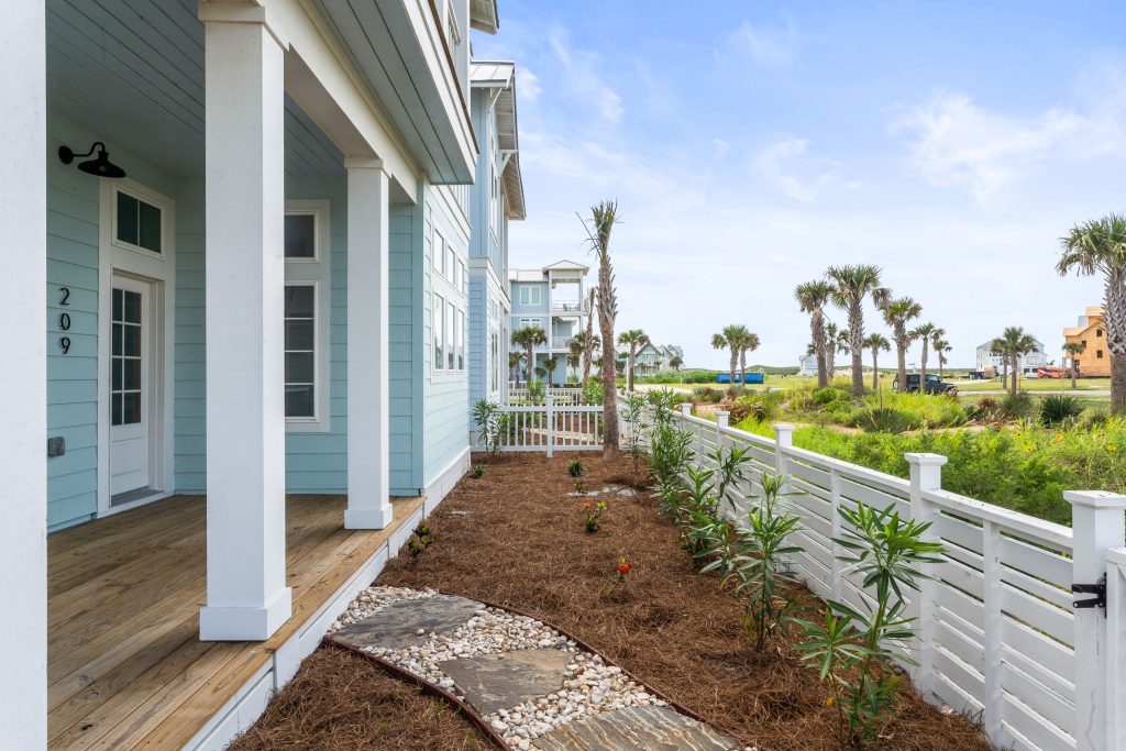 Side porch and landscaped yard at 209 Horse Tail Lane